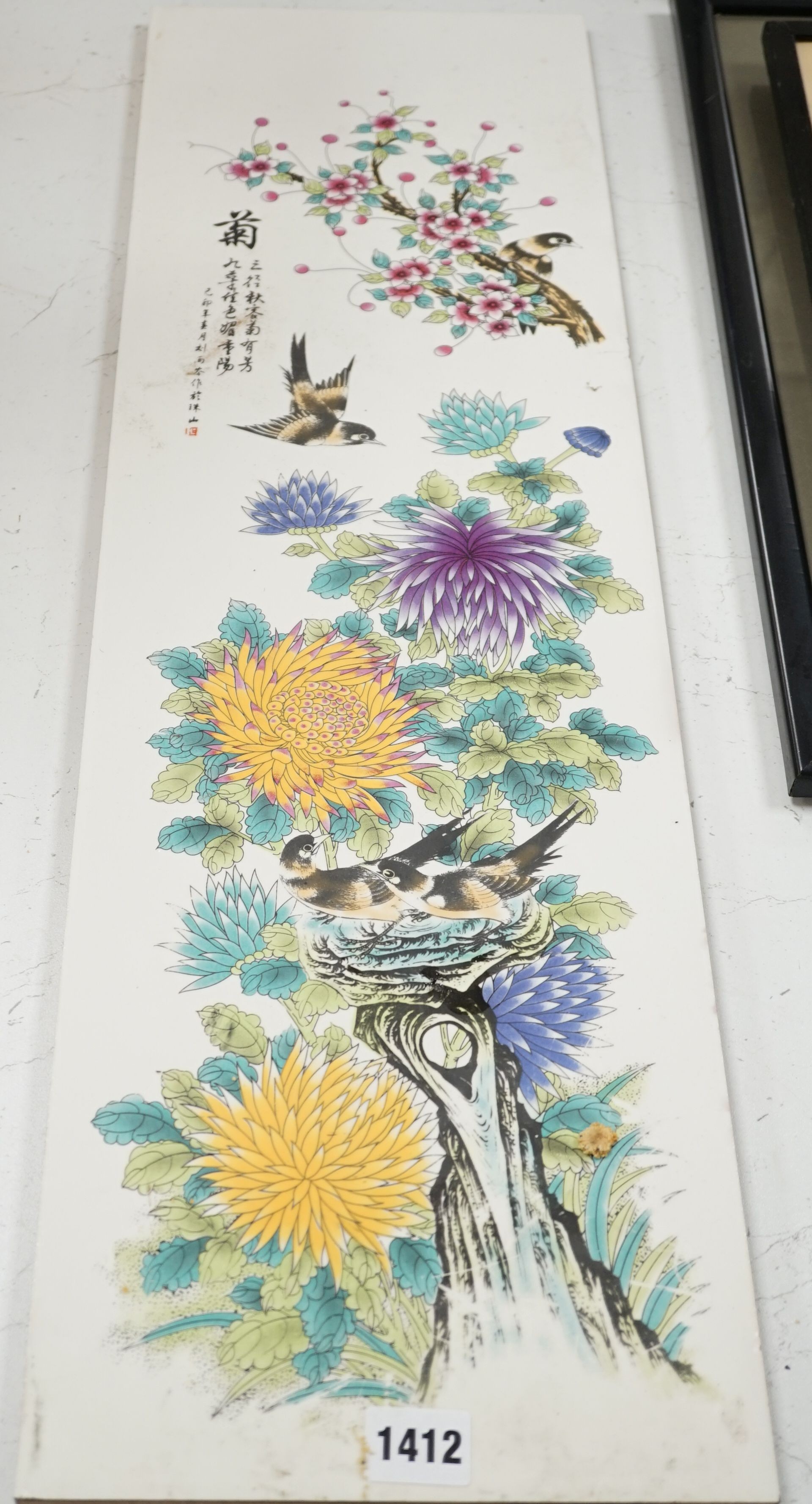 A Chinese enamelled tile, decorated with birds and flowers, 75 cms high x 22 cms wide.